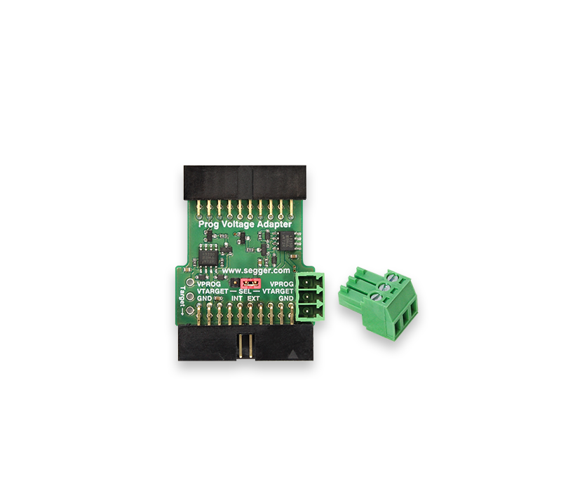This image shows a Prog Voltage Adapter circuit board with labeled connectors. It features a green PCB with various pins and connections for programming, including inputs for voltage and ground. A small, detachable green connector is also visible next to the adapter.
