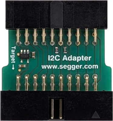 The image shows an I2C adapter, a small green printed circuit board with pins for connections. It features a small chip and the text "I2C Adapter" along with the website "www.segger.com" printed on its surface. The left side indicates a target connection.
